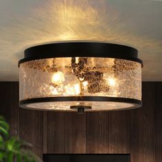 a light fixture in a room with wood paneling and lights on the ceiling above it