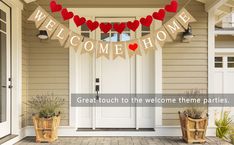 a welcome home banner with hearts hanging from it's front door and potted plants