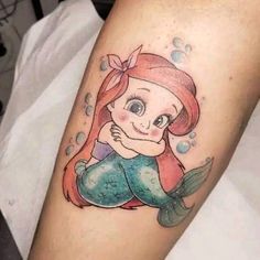 the little mermaid is sitting on her stomach