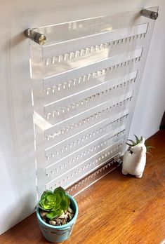 a potted plant sitting on top of a wooden floor next to a radiator