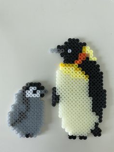 two penguins made out of legos sitting next to each other