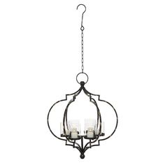 an iron chandelier with three candles hanging from the front and back ends, on a white background