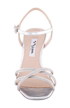 Luxe rhinestones trimming the straps and buckle bring sparkle to every step you take in an elegant sandal lifted by a comfortably low heel perfect for dancing. 2 1/4" heel Synthetic upper, lining and sole Imported Silver Sandals Flat, Silver 4-inch Kitten Heels For Party, Elegant Silver Sandals With 4-inch Heel, Silver Sandals With 4-inch Heel, Silver Kitten Heels With 4-inch Heel, Silver Sandals With 4-inch Heel And Ankle Strap, Elegant Sandals, Silver Sandals, Strap Sandals Women