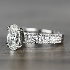 an oval cut diamond ring with pave set diamonds on the band