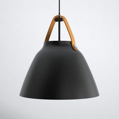 a black and wooden light hanging from a ceiling fixture with an orange cord attached to it