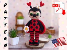 a crocheted ladybug doll holding a flower