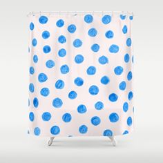 a shower curtain with blue polka dots on it