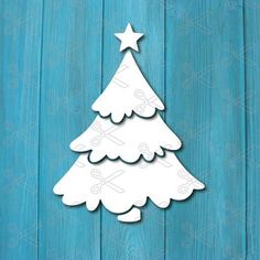 a paper cutout of a christmas tree on a blue wooden background with the word merry written