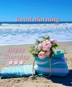 a beach bag with flowers on it sitting in the sand next to the ocean and words good morning happy thursday