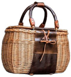 a wicker bag with brown leather handles