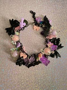 Add a touch of pastels and darkness to your outfit this season with this pastel goth charm bracelet! With pinks, purples, and black to give it a cute yet dark vibe, this charm bracelet will be the highlight your outfit🖤. Check out our charm bracelets section for more unique designs! Product info: *Made with stainless steel materials *Adjustable, reaches up to 6.5 inches *Charm materials consist of plastic, acrylic, resin If you have any questions, please don't hesitate to ask! We are friendly:) Visit our official website: www.yeetincolorboutique.com and follow us on Instagram: @yeetincolorboutique Jewelry Kawaii, Bubble Goth, Pastel Goth Fashion, Kawaii Goth, Goth Jewelry, Outfit Check, Goth Aesthetic, Halloween Jewelry, Pastel Goth