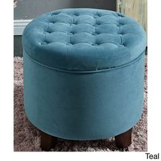 a blue ottoman sitting on top of a shaggy rug