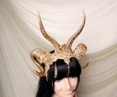 Gold Ram horns Headdress This spectacular, shiny Gold crown, is made with Gold double horns, a beautiful jeweled centerpiece, rich gold embellishments, lace and crystals. This piece is glitters and sparkles with every move. Elegant and regal, this headdress is ideal for making a statement. It can be a great addition to any fantasy costume - SunGoddess, High Priestess, Greek goddess or Queen. Can be used as a pagan headpiece or tribal headpiece carnival. A beautiful and sparkly headdress that is Gold Fantasy Costume Hats And Headpieces For Halloween, Fantasy Gold Costume Hats And Headpieces For Halloween, Fantasy Gold Costume Hats And Headpieces For Masquerade, Fantasy Gold Costume Hat For Halloween, Gold Fantasy Costume Hat For Halloween, Gold Fantasy Costume Hat With Tall Crown, Fantasy Style Gold Costume Hat For Festivals, Fantasy Festival Costume Hats And Headpieces In Gold, Gold Tall Crown Fantasy Hat