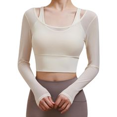 PRICES MAY VARY. A two-in-one yoga outfit. The outer layer is a long-sleeved piece of mesh fabric, and the inner layer is a medium support sports bra. Mesh short sleeves-95% nylon and 5% spandex. Sports bra -81% nylon and 19% spandex. Padded sports bra. Featuring an elastic hem and fixed line design, providing additional coverage and shape support. The non removable padding also prevents the bra from shifting and is easy to clean. Applicable scenarios. Long Sleeve Athletic Top is suitable for yo Long Sleeve Moisture-wicking Activewear For Layering, Long Sleeve Moisture-wicking Activewear, White Compression Top For Pilates, Stretch Athleisure Crop Top For Layering, Solid Tops With Medium Support For Yoga, Athleisure Stretch Crop Top For Layering, Sportswear Tops With Light Support For Pilates, Functional Yoga Tops With Thumbholes, Versatile Yoga Tops With Thumbholes