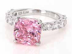 a pink diamond ring with white diamonds around it