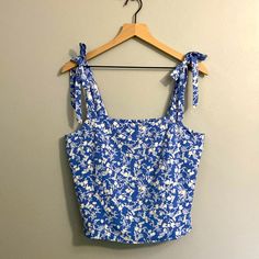 98% Polyester, 2% Spandex. Size L, Tags Still Attached And Never Worn. Adjustable Tie Straps. True To Size. Cropped Tank And Sits Right At Waist, Perfect For High-Rise Bottoms/Skirts. Super Comfortable And In Excellent Condition. Height Laying Flat: 20 Inches Chest And Waist Laying Flat: 17 Inches Blue Summer Tank Top With Tie Straps, Blue Tank Top With Tie Straps For Summer, Summer Blue Tank Top With Tie Straps, Blue Sleeveless Tops With Tie Straps, Blue Summer Tops With Tie Straps, Blue Tie Straps Tops For Summer, Blue Cotton Tops With Tie Straps, Blue Cotton Top With Adjustable Straps, Trendy Blue Top With Tie Straps