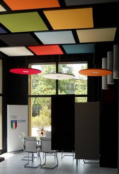 an office with multicolored ceiling and chairs