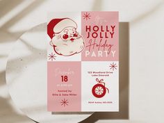 a pink and white holiday party card with santa clause on it's face, next to a plate