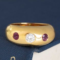 A perfect addition to any Cartier collector's jewelry wardrobe. A bright and sparkly diamond is flanked by a a pair of beautiful and richly hued rubies, all in rich yellow gold. Perfectly proportioned, and a great ring to reach for on the daily.18kt yellow gold, size XX & resizable.Stamped "Cartier" "750"*Qualitative report to follow. Luxury Gold Domed Ruby Ring, Classic Yellow Gold Three Stone Ruby Ring, Classic Three Stone Ruby Ring In Yellow Gold, Classic Three Stone Yellow Gold Ruby Ring, Luxury Three Stone Ruby Ring, Classic Yellow Gold Ruby Ring With Single Cut Diamonds, Luxury Yellow Gold Ruby Ring With Single Cut Diamonds, Formal Yellow Gold Ruby Ring With Single Cut Diamonds, Gold Ruby Ring With Single Cut Diamonds