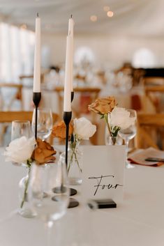 the table is set with candles and place cards for guests to write their names on