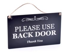 a black and white sign that says please use back door thank you on the front