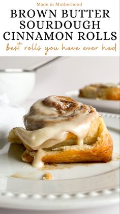 A brown butter sourdough cinnamon roll on a plate, topped with brown butter, cream cheese frosting. Brown Sugar Cinnamon Roll Icing, Brown Butter Sourdough Discard Cinnamon Knots, Brown Butter Sourdough Cinnamon Rolls, Sourdough Pecan Rolls, Active Sourdough Cinnamon Rolls, Sourdough Spread Ideas, Sourdough Pastry Dough, Sourdough Brunch Ideas, Soft Cinnamon Rolls Recipe