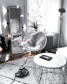 a living room filled with furniture and a white rug