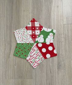 four christmas napkins on the floor with snowmen and polka dotes in them