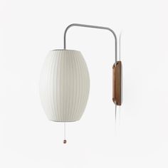 a white wall light with a wooden arm