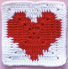 a crocheted square with a red heart on it