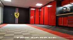 a large garage with red cabinets and checkered flooring on the floor is shown