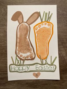 a drawing of two carrots with the words happy easter written on them and an animal's foot