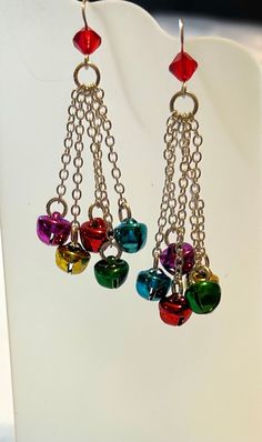 "Pretty 6mm Siam (Red) Swarovski crystal bicone above 5 pretty little Christmas colored (green, red and gold) bells.  Suspended on French hooks.   Order yours now - be the first in your office to have a pair!  Earrings are 2\" long below the ear wire. (Bells tinkle very lightly - not annoying or distracting - and are light weight) Earrings come in a gift box." Christmas Beaded Dangle Earrings With Ear Wire, Christmas Red Earrings With Colorful Beads, Christmas Bell Earrings, Christmas Colorful Beaded Dangle Earrings, Multicolor Christmas Earrings, Swarovski Crystal Jewelry, Dragonfly Earrings, French Wire, Swarovski Crystal Earrings