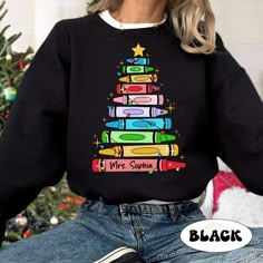 "Personalized Christmas Teacher Shirt, Teacher Crayon Christmas Tree Shirt, Retro Cute Teacher Christmas Sweatshirt, Teacher Christmas Gift ↓ Click here to view our additional fashionable collections ↓ https://handcraftedbyhelenn.etsy.com Product Details: - 100% Cotton (fiber content may vary for different colors) - Medium fabric (5.3 oz/yd2 (180 g/m2)) - Classic fit - Tear away label - Runs true to size Care instructions: - Machine wash: warm (max 40C or 105F); - Non-chlorine: bleach as needed; Christmad Teacher Shirts, Teacher Christmas Sweatshirt, Personalized Teacher Christmas Gifts, Teacher Christmas Sweater, Cute Christmas Teacher Gifts, Christmas T-shirts, Christmas Teacher Shirts, Teacher Christmas Shirts, Christmas Teacher Gifts