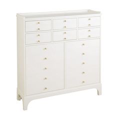 a white dresser with six drawers and gold knobs on the top, against a white background