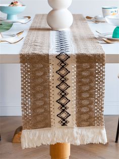 a table with a brown and white runner on it