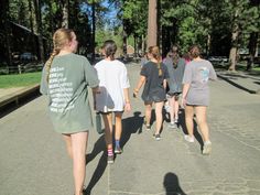 several girls are walking down the street together