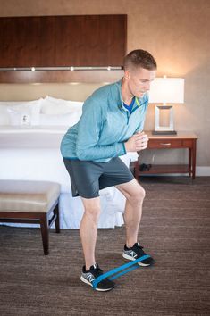 a man standing on a pair of skis in a hotel room