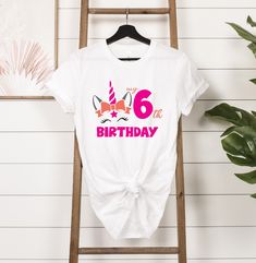 My 6th Birthday Unicorn Shirt, 6th Birthday Shirt, 6 Year Old Birthday, Six Birthday Shirt, Girl Birthday Shirt, Sixth Birthday Shirt HOW TO PLACE YOUR ORDER * Choose your t-shirt color * Choose your size * Choose your design&text color * PLEASE make sure all your order's steps PRODUCT DESCRIPTION T-shirt feels soft and light, with just the right amount of stretch. It's comfortable and the unisex cut is flattering for both men and women. * Solid colors are 100% combed and ring-spun cotton * Ash color is 99% combed and ring-spun cotton, 1% polyester * Heather colors are 52% combed and ring-spun cotton, 48% polyester * Athletic and Black Heather are 90% combed and ring-spun cotton, 10% polyester * Heather Prism colors are 99% combed and ring-spun cotton, 1% polyester * Fabric weight: 4.2 oz/ Pink Unicorn Print T-shirt For Birthday, Birthday Unicorn Print Crew Neck T-shirt, Birthday White T-shirt With Unicorn Print, White Unicorn Print T-shirt For Birthday, White Unicorn Print Top For Birthday, White T-shirt With Unicorn Print For Birthday, 6th Birthday Shirt, Sixth Birthday, Birthday Unicorn