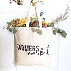 Our 100% cotton canvas farmers market tote bags are perfect for everyday use! These beautiful natural canvas shopping bags are great for a quick run to the grocery store or the local farmers market. Silly and unique, these eco-friendly handbags are a must-have for carrying fresh fruits and vegetables, books, clothes, accessories and many more!   #cottonandcanvasco #farmersmarket #totebag #tote #shoppingbag #giftforher Cotton Canvas Tote Bag For Market, Spring Canvas Shopping Bag, Eco-friendly Spring Market Bags, Eco-friendly Cotton Canvas Market Bag, Farmers Market Canvas Bags, Farmers Market Tote Bag, Eco Friendly Handbags, Funny Tote Bags, Market Tote Bag