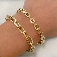 "This Italian handcrafted chain link bracelet is completely composed of 14K solid gold and is uniquely made with a semi-hollow interior for comfortable everyday wear that will not dent. This bracelet is available in a variety of different length options. ♦ Total Length: your choice of 6.5, 7, 7.5, 8 or 8.5 inches ♦ Link Dimensions: approximately 6mm (w) x 8.75mm (l) x 1.8mm thick ♦ Weight: 5.1 grams of 14K solid gold in the 7.5\" option ♦ Metal Finish: High Shine Polish ♦ This design is currentl Gold Cable Chain Bracelet As Gift, Gold Cable Chain Link Bracelet, Gold-plated Paperclip Chain Bracelet With Oval Links, Gold Paperclip Bracelet With Oval Link, Oval Link Paperclip Bracelet As Gift, Gold Oval Link Cable Chain Bracelet, Gold Bracelet With Rectangular Cable Chain Links, Gold Link Bracelet With Rolo Chain, Gold Rolo Chain Link Bracelet