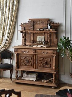 an old fashioned wooden cabinet in the corner of a room