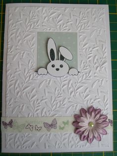 a close up of a greeting card with a flower on the front and an image of a bunny