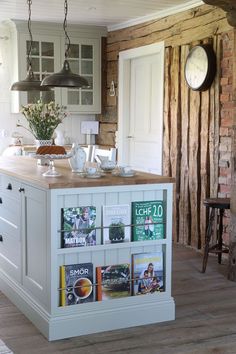 a kitchen island with magazines on it