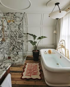 a bath tub sitting next to a shower in a bathroom