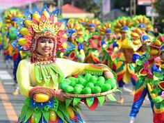 a group of people that are walking down the street with some fruit in their hands