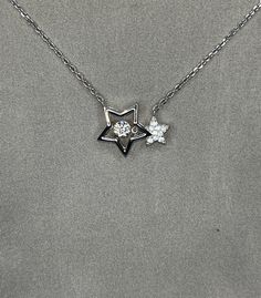 "Star Necklace Moissanite Diamond Dancing Stone Stars Necklace 925 Sterling Silver Necklace Bridesmaid Anniversary Gift Chain Size: 15.5\" - 17.5\" (39.5 cm - 44.5 cm) Adjustable Pendant Size: 2 cm X 1.4 cm Main Stone Size: 4 mm Main Stone: Moissanite Diamond Feature : New jewelry concept which allows the stone to continually move to create a consistent sparkle, alluding to the vision of \"dancing\" stone. Main Stone Color: Clear White Main Stone Shape: Round Cut Metal: Real Solid 925 Sterling Silver Hallmark: 925 Stones Setting: Prong Finish: High Polished Comes in a wrapped gift box" Sterling Silver Necklace With Star Charm For Anniversary, Dazzling Star-shaped White Gold Necklace, Dazzling Star Shaped White Gold Necklace, Dazzling White Gold Star Necklace, Star-shaped Silver Diamond Necklace For Anniversary, Silver Star-shaped Diamond Necklace For Anniversary, Fine Jewelry Star-shaped Necklace For Anniversary, Star-shaped Fine Jewelry Necklace For Anniversary, Anniversary Silver Star-shaped Diamond Necklace