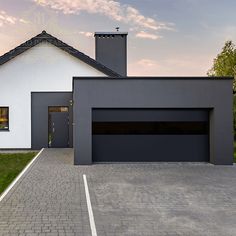 a white house with a black garage door