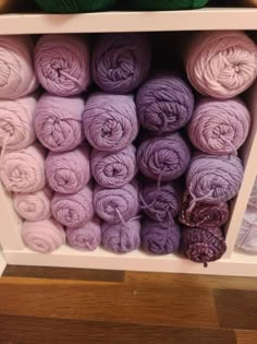 several skeins of yarn are stacked on a shelf