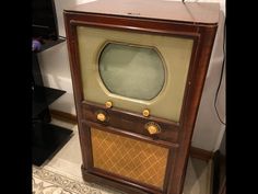 an old fashioned tv sitting on top of a table